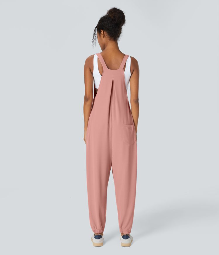 Jogger jumpsuit with adjustable belt and buttons, multiple pockets, and waffle pattern