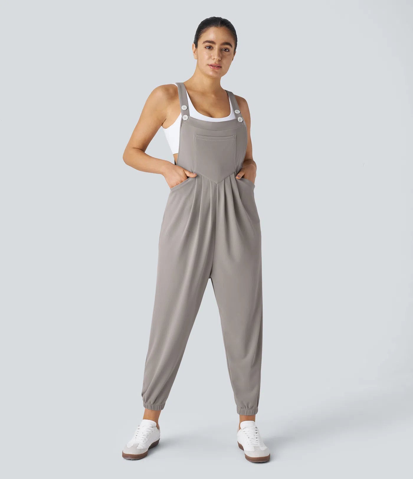 Jogger jumpsuit with adjustable belt and buttons, multiple pockets, and waffle pattern