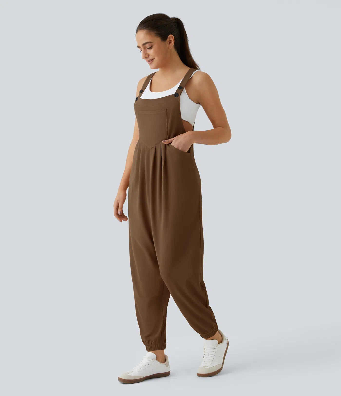 Jogger jumpsuit with adjustable belt and buttons, multiple pockets, and waffle pattern