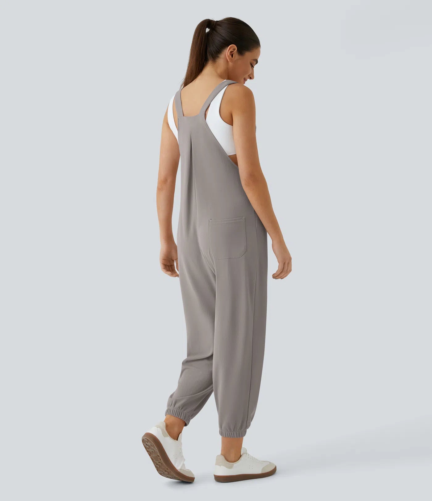 Jogger jumpsuit with adjustable belt and buttons, multiple pockets, and waffle pattern