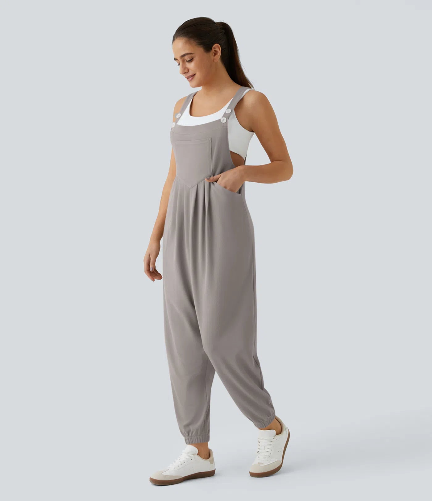 Jogger jumpsuit with adjustable belt and buttons, multiple pockets, and waffle pattern