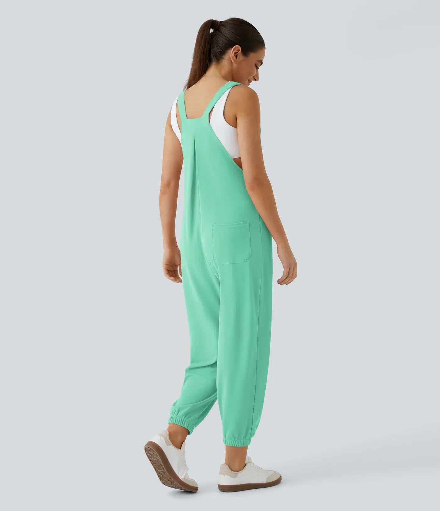 Jogger jumpsuit with adjustable belt and buttons, multiple pockets, and waffle pattern
