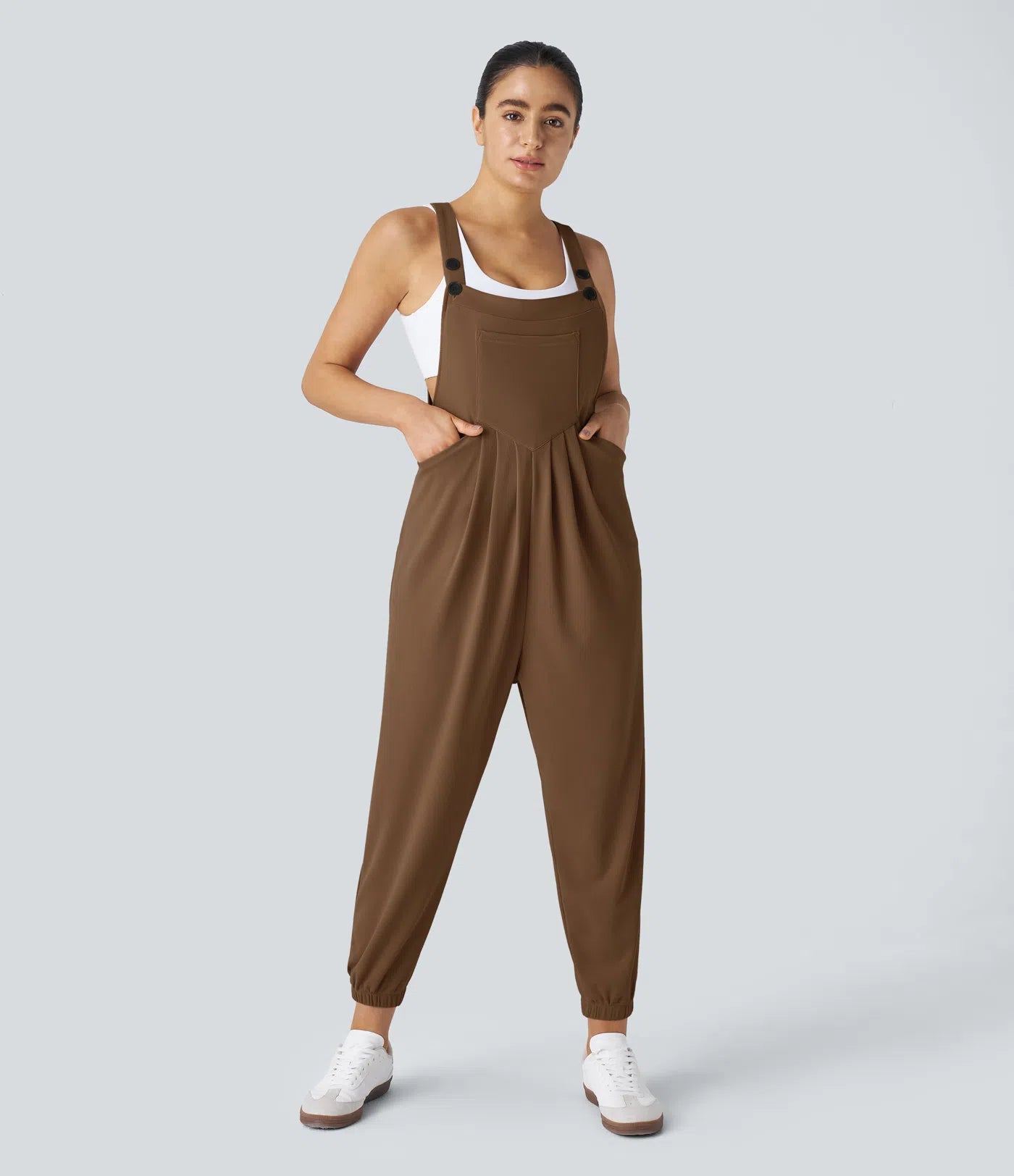 Jogger jumpsuit with adjustable belt and buttons, multiple pockets, and waffle pattern