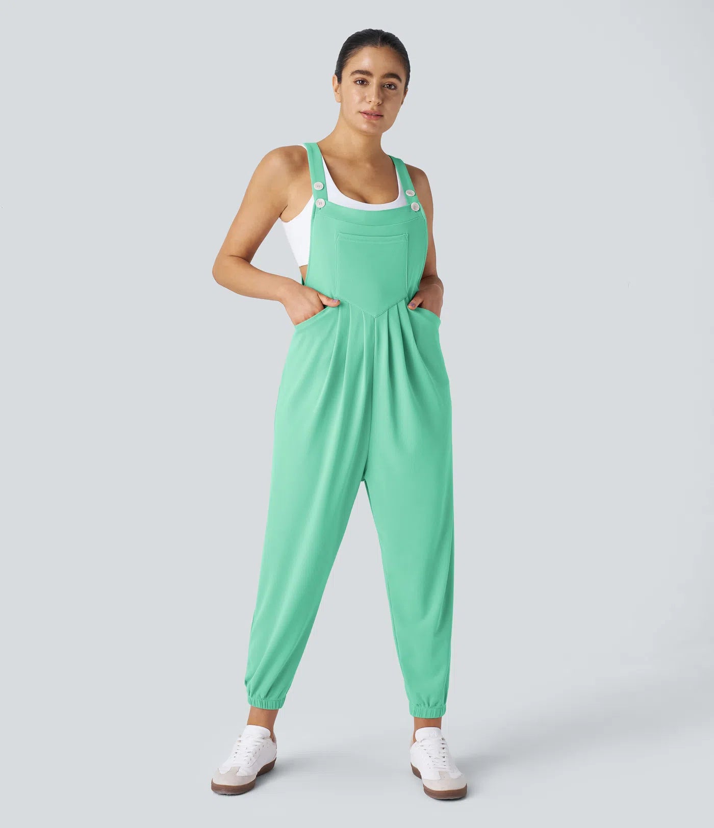 Jogger jumpsuit with adjustable belt and buttons, multiple pockets, and waffle pattern