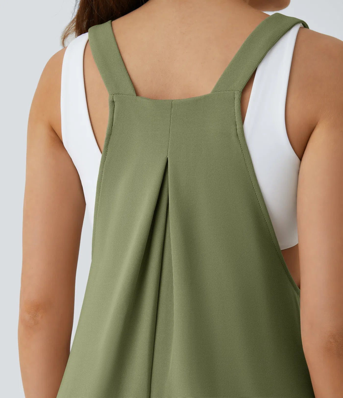 Jogger jumpsuit with adjustable belt and buttons, multiple pockets, and waffle pattern