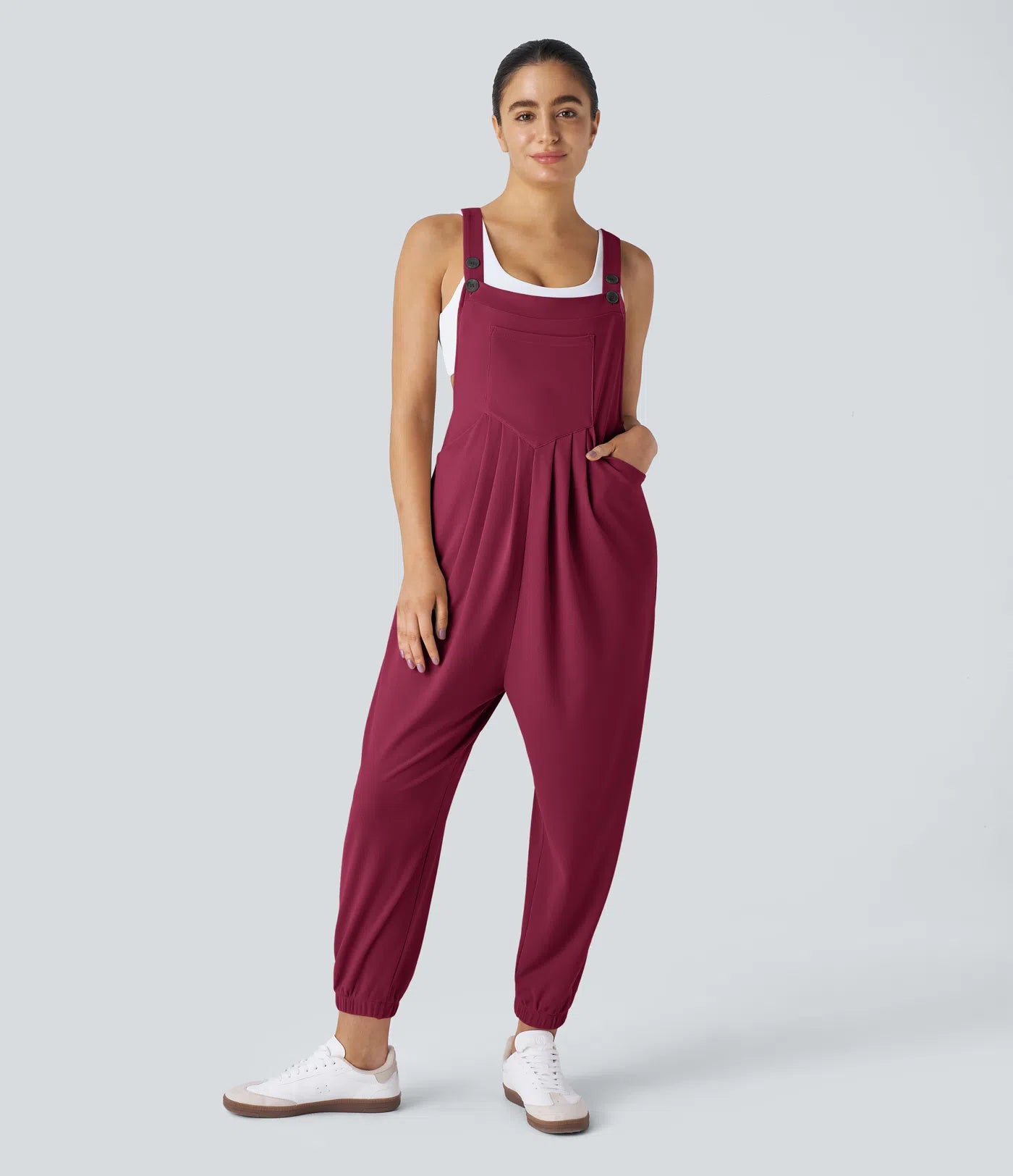 Jogger jumpsuit with adjustable belt and buttons, multiple pockets, and waffle pattern