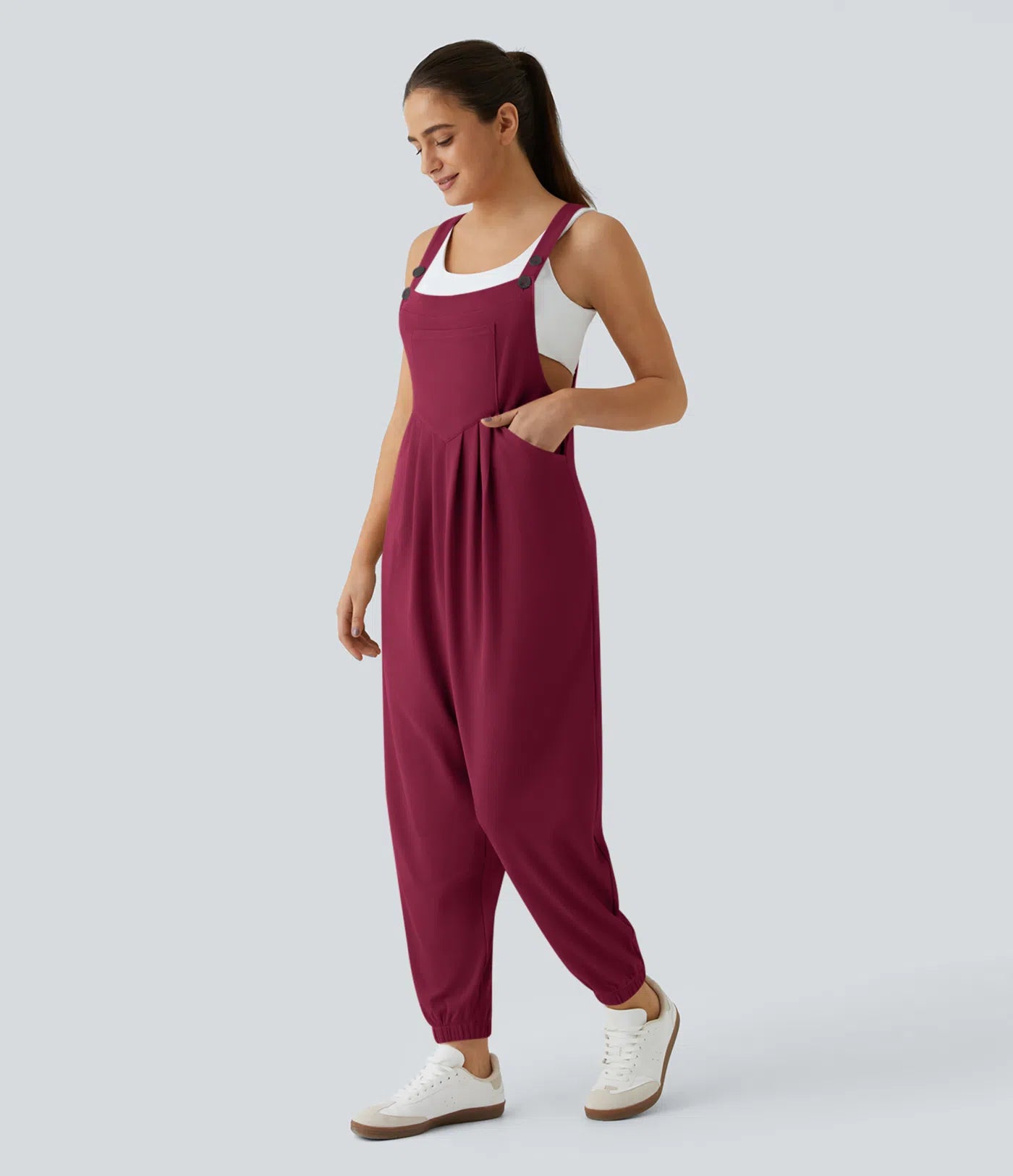 Jogger jumpsuit with adjustable belt and buttons, multiple pockets, and waffle pattern