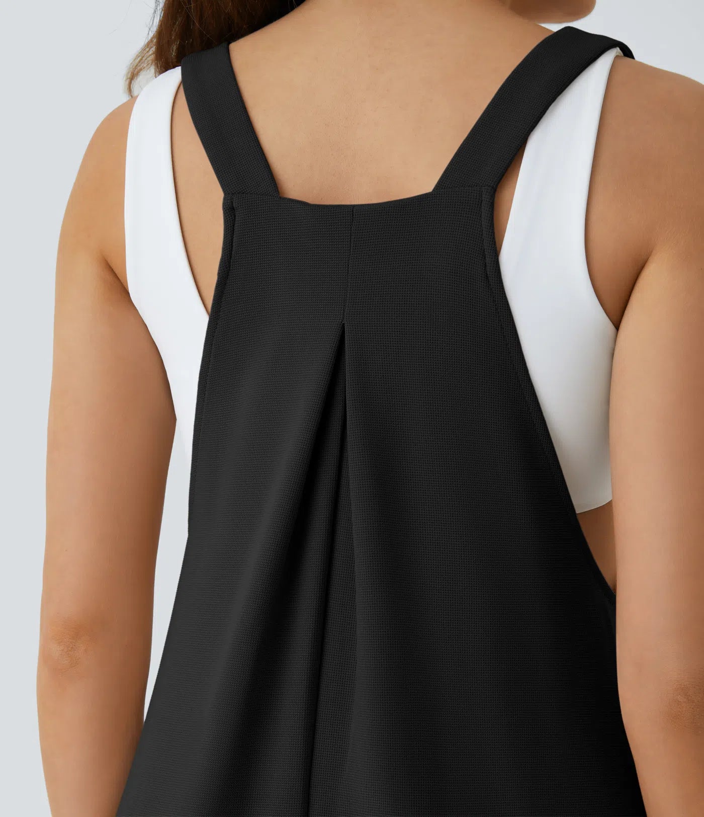 Jogger jumpsuit with adjustable belt and buttons, multiple pockets, and waffle pattern