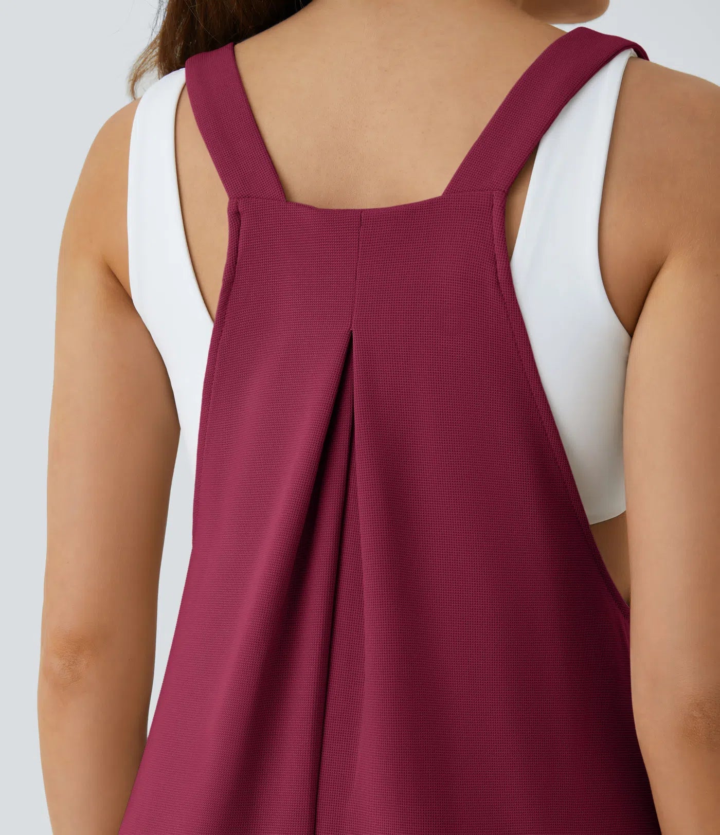 Jogger jumpsuit with adjustable belt and buttons, multiple pockets, and waffle pattern