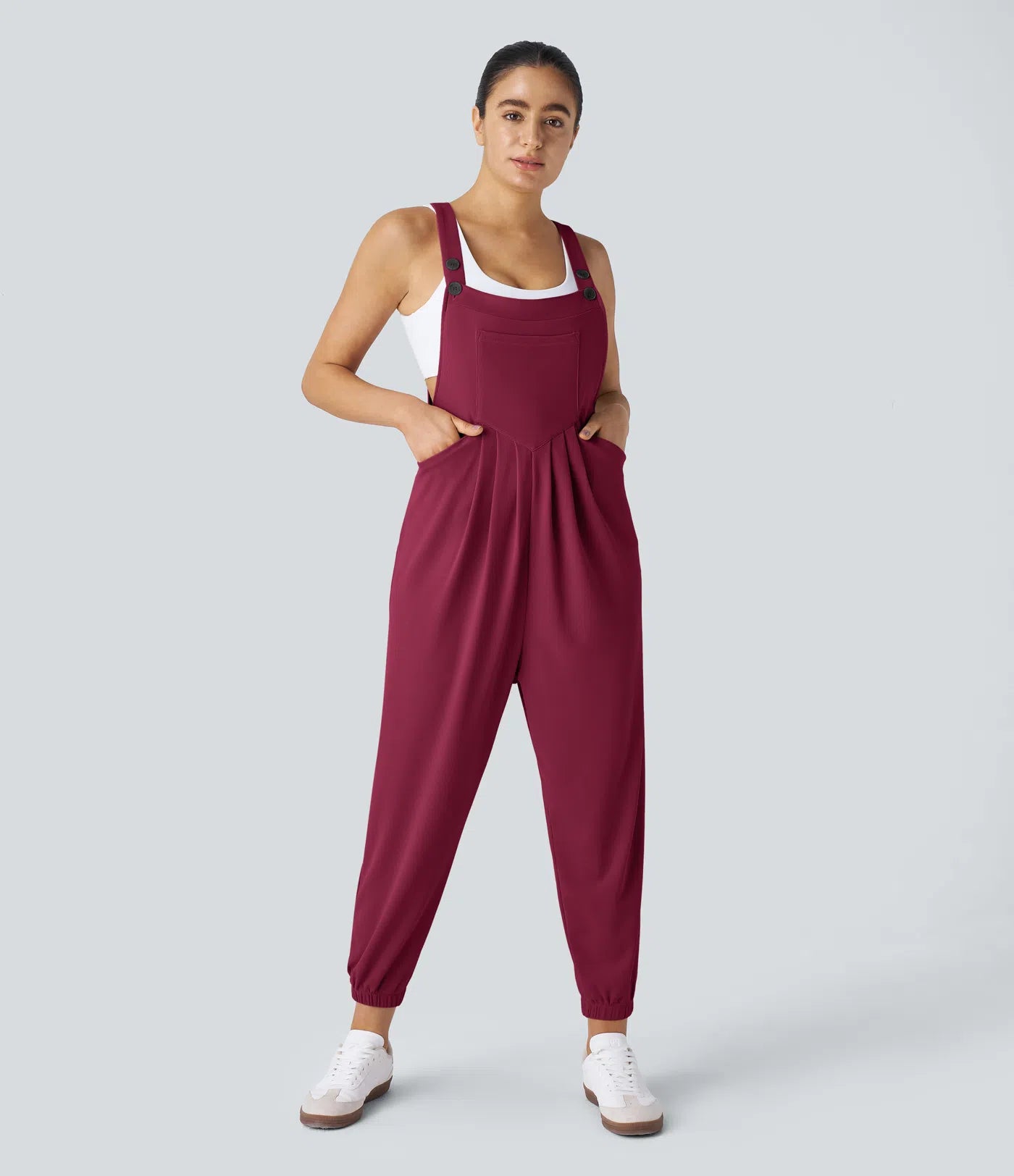 Jogger jumpsuit with adjustable belt and buttons, multiple pockets, and waffle pattern