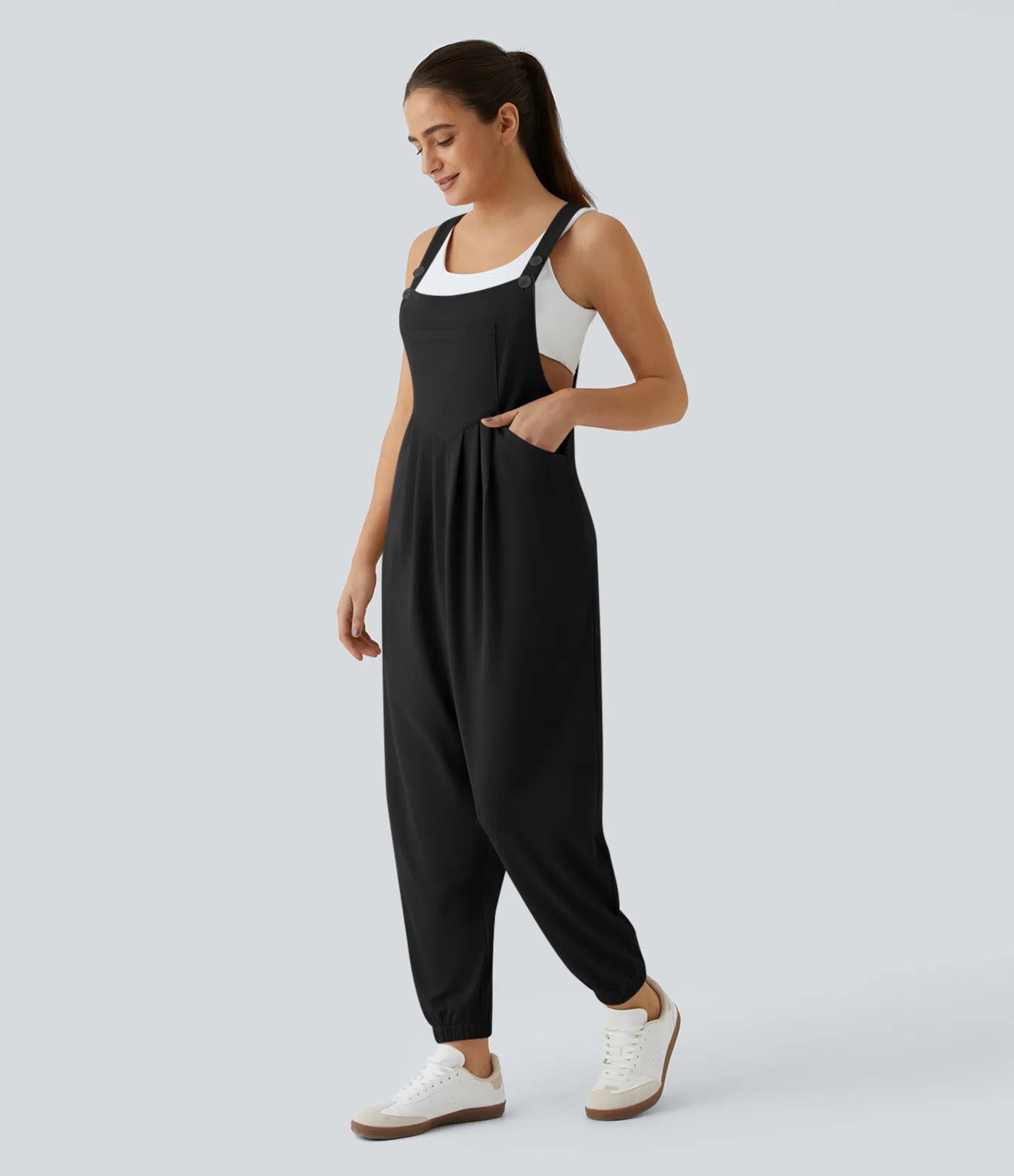 Jogger jumpsuit with adjustable belt and buttons, multiple pockets, and waffle pattern