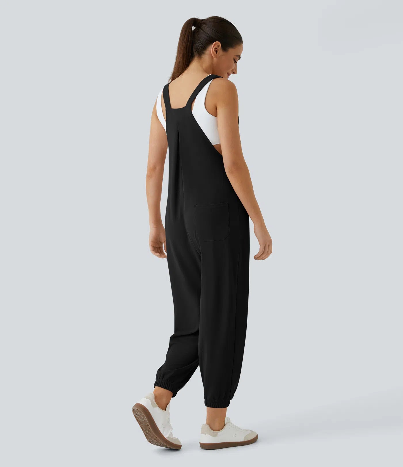 Jogger jumpsuit with adjustable belt and buttons, multiple pockets, and waffle pattern
