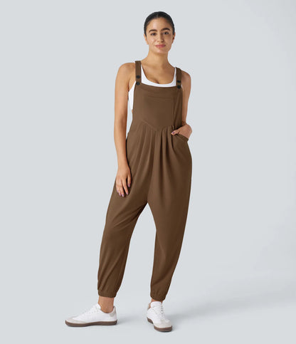 Jogger jumpsuit with adjustable belt and buttons, multiple pockets, and waffle pattern