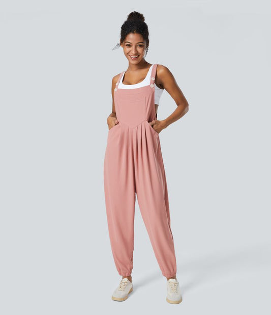 Jogger jumpsuit with adjustable belt and buttons, multiple pockets, and waffle pattern
