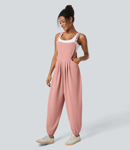 Jogger jumpsuit with adjustable belt and buttons, multiple pockets, and waffle pattern