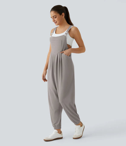 Jogger jumpsuit with adjustable belt and buttons, multiple pockets, and waffle pattern