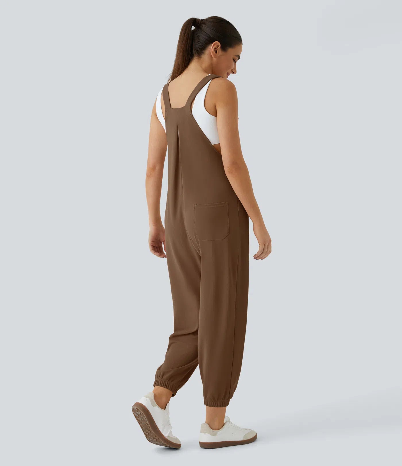 Jogger jumpsuit with adjustable belt and buttons, multiple pockets, and waffle pattern