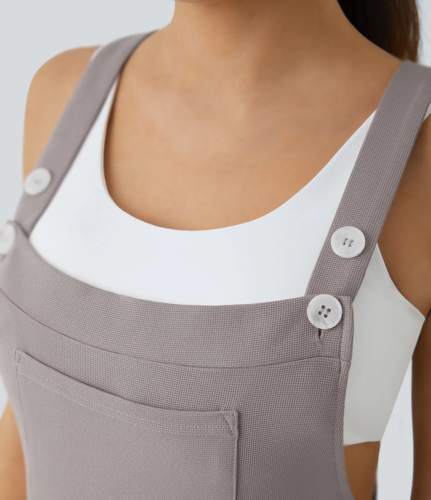 Jogger jumpsuit with adjustable belt and buttons, multiple pockets, and waffle pattern