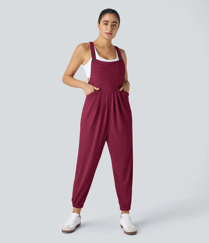 Jogger jumpsuit with adjustable belt and buttons, multiple pockets, and waffle pattern