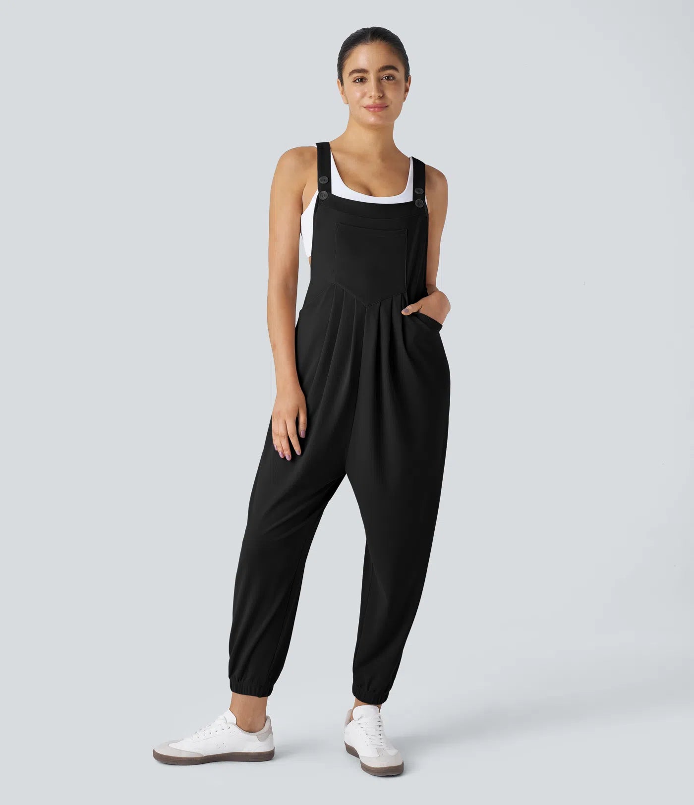 Jogger jumpsuit with adjustable belt and buttons, multiple pockets, and waffle pattern